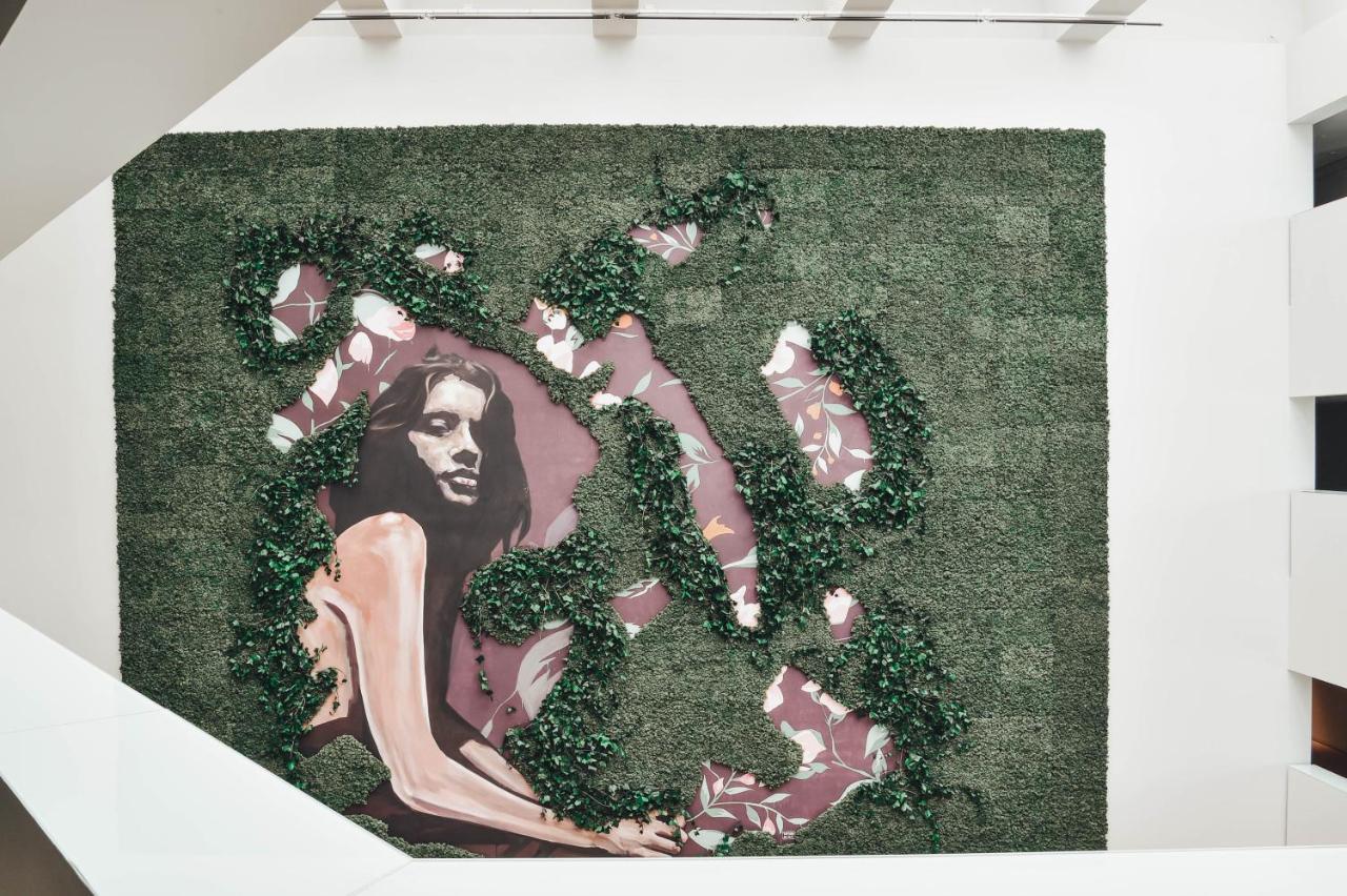 The Editory By The Sea Troia Comporta Hotel Exterior photo A green wall with a picture of a woman